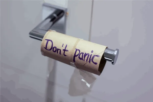 Empty toilet paper roll with "Don't panic" written on it